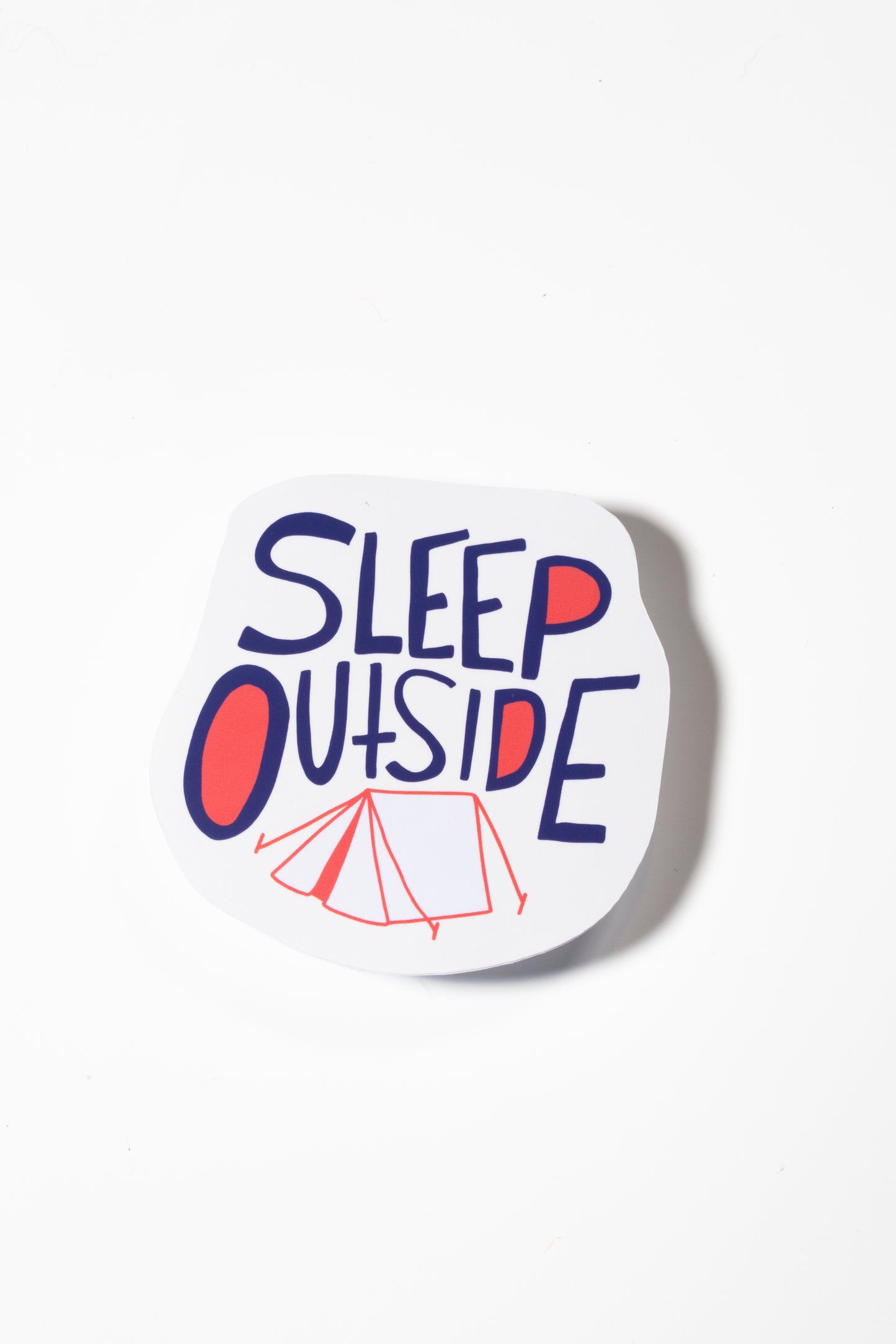 Sticker that reads "Sleep Outside" in blue and red with a small tent drawing on a white sticker shot on a white background.