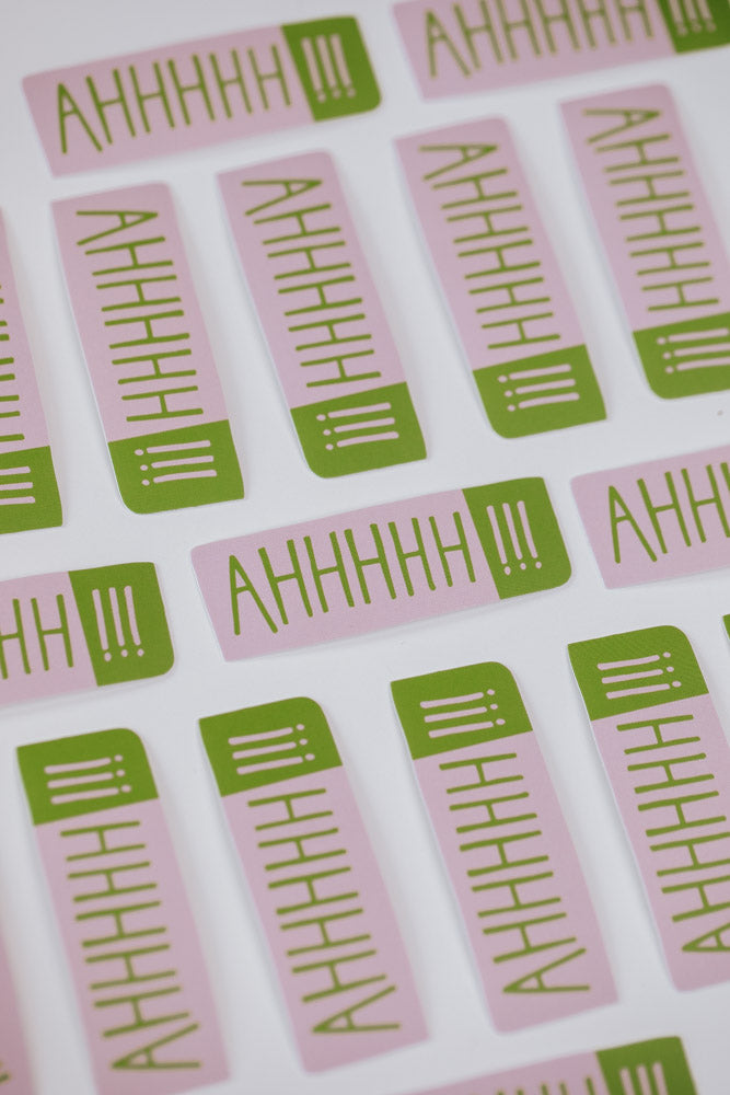 A colorful pile of stickers featuring the word "ahh" prominently displayed on each one.