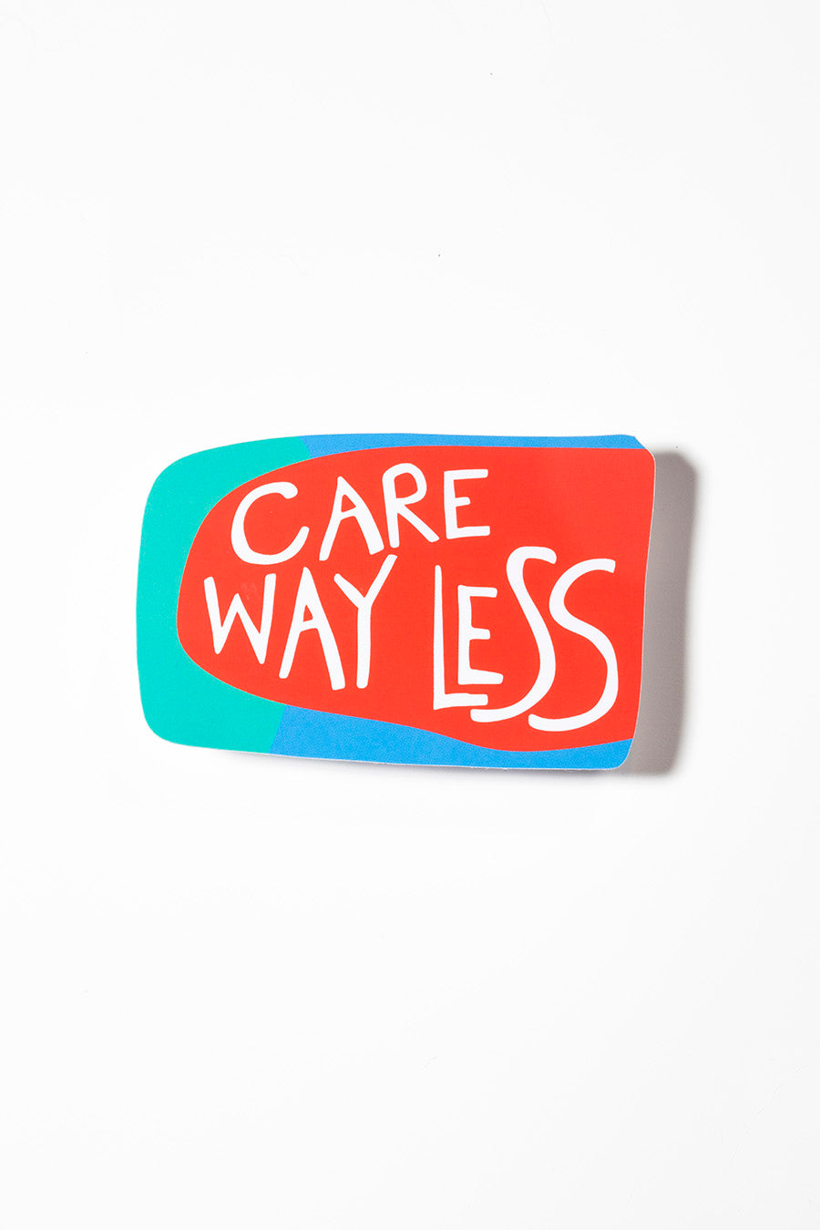 Red, teal, and blue sticker that reads "Care way less" in a white handwritten font photographed on a white background.