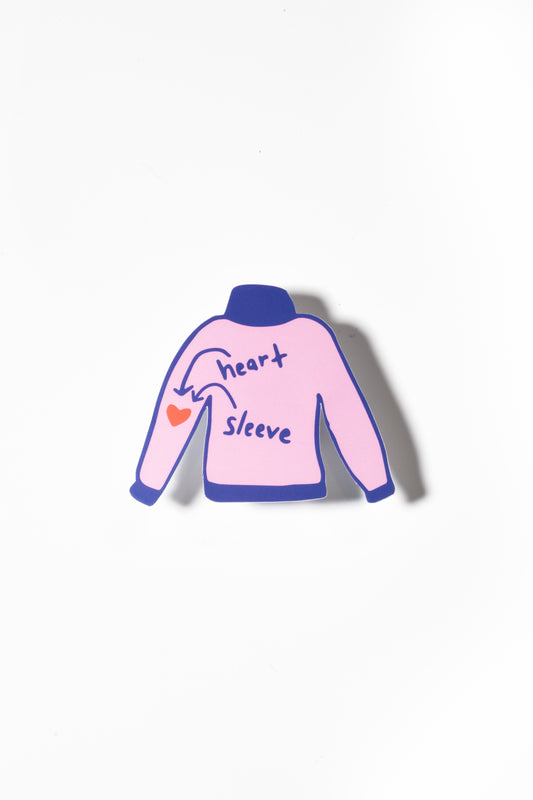 Pink sweater illustration with text labeling "heart" and "sleeve," pointing to a small red heart on the left sleeve.