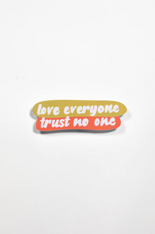  A vibrant design with the text "love everyone trust no one" displayed in bold, colorful lettering against a plain white background.