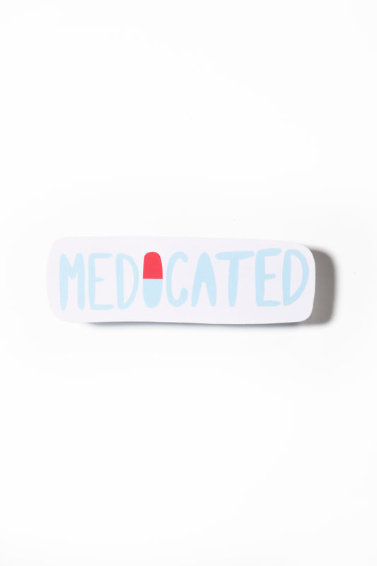 A white sticker with the text "MEDICATED" printed on it in blue and red lettering.